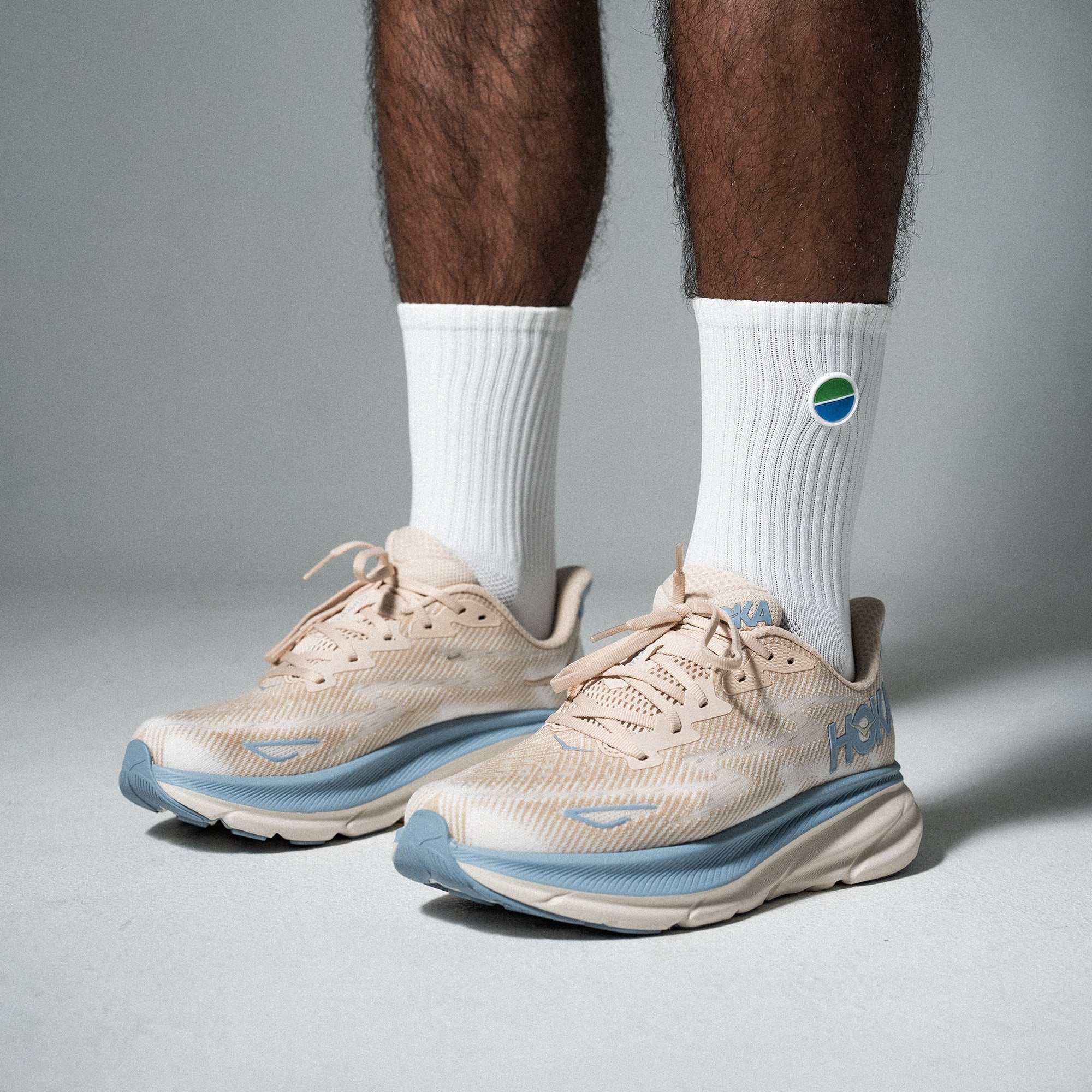 White V3 Core Performance Socks for running and gym, shown with athletic shoes.